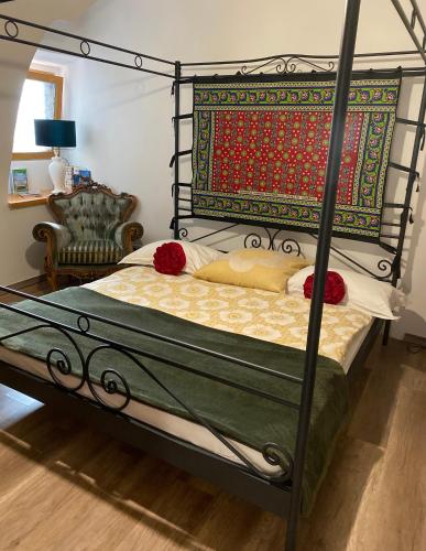 a bedroom with a bed with a metal frame at Apartman Modrý dom in Levoča