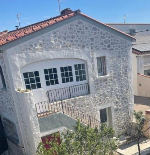 a stone house with a large white garage at Torreilles-Casa terracota-plage - visa image- les déferlantes le Barcares - South of France in Torreilles