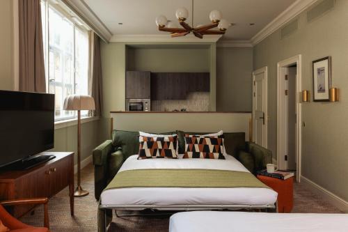 a bedroom with a bed and a flat screen tv at Native Glasgow in Glasgow