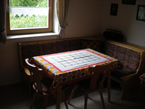 a table with a chess board on top of a couch at Erlebnishof Schiman in Kirchbach