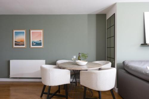 a dining room with a table and chairs and a couch at 6 The Point, Newquay in Newquay