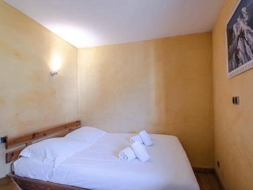sypialnia z łóżkiem z dwoma białymi ręcznikami w obiekcie Joli appartement rénové avec balcon proche zone piétonne - FR-1-343-164 w Chamonix-Mont-Blanc