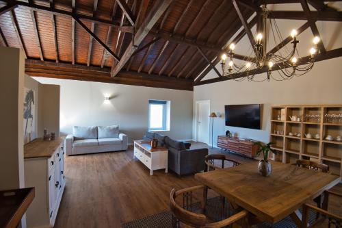 a large living room with a table and a couch at Sorraia Hotel Rural in Santa Justa