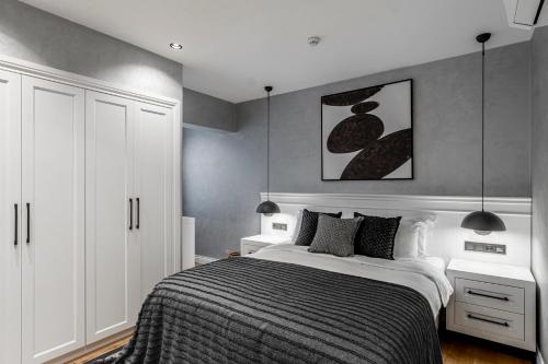 a bedroom with a bed and two white cabinets at Ena Boutique Hotel & Residences in Bodrum City