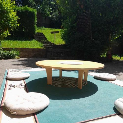 a round table and two stools on a blue carpet at Villa Sabic in Sarajevo