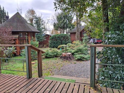 a wooden walkway leading to a garden with a house at Cabanas Mapulauquen in Pucará