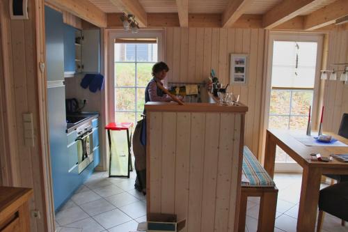 a woman standing at a counter in a kitchen at Feenwald - Baabe in Baabe