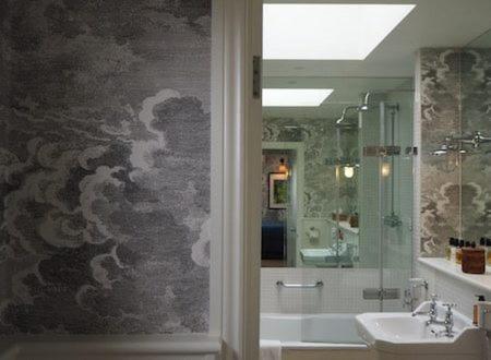 a bathroom with a shower and a sink and a bath tub at The Old Bridge in Huntingdon