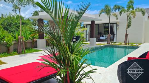 a villa with a swimming pool and a resort at Santi Tara Villas in Amphoe Koh Samui