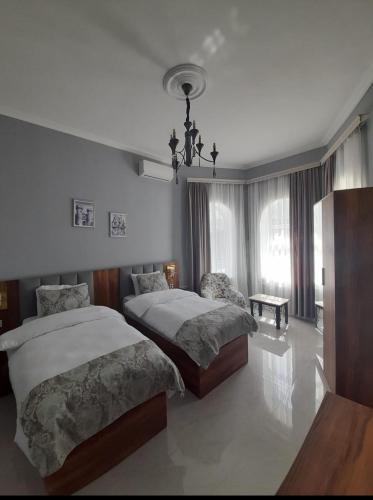 a bedroom with two beds and a window at Holiday inn Adnan boutique hotel and pool in Gabala