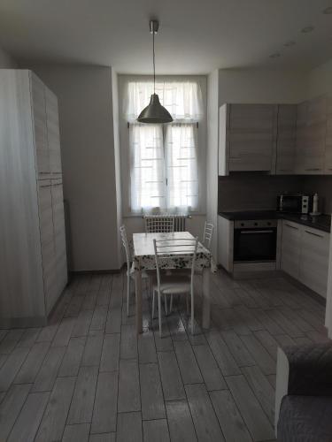a kitchen with a table and chairs in a room at La CasaLina in Omegna