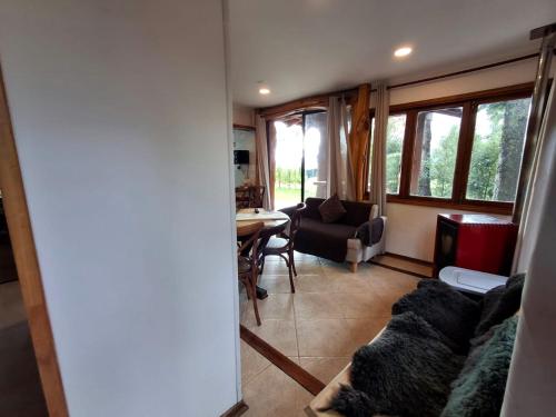 a living room with a couch and a table at Cabanas Mapulauquen in Pucará