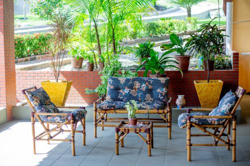 a patio with chairs and potted plants at Pousada Recanto das Orquídeas in Barreirinhas