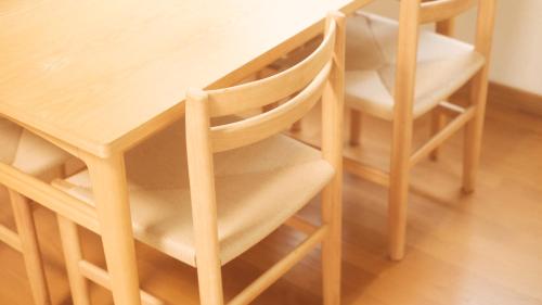a wooden table with two chairs and a table and a table at Kamakura Hase House in Kamakura