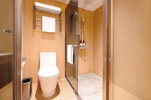 a bathroom with a toilet and a shower at Ji Hotel Orchard Singapore in Singapore