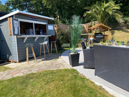 a small building with a bar in a yard at The Belmont in Shanklin
