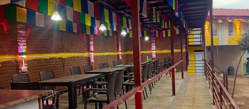 a row of tables and chairs in a room with colorful flags at Everest Home Stay Temal Kalimati Tower in Thapathali