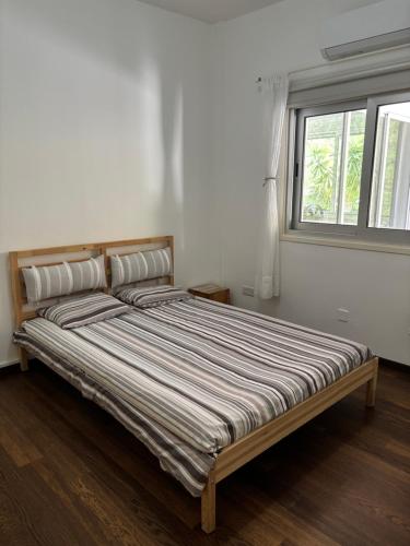 a bed in a white room with a window at 3 Bedroom Oceanfront Oasis for Memorable Vacations in Voroklini