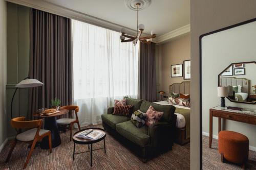 a living room with a green couch and a table at Native Glasgow in Glasgow