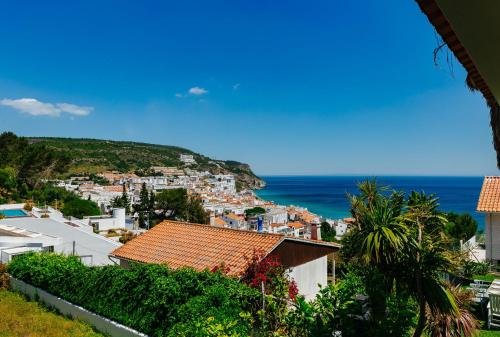 a view of the town of positano and the ocean at Panoramic Ocean View Villa & Pool in Sesimbra by Rent4Rest in Sesimbra