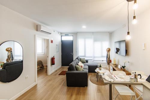 a living room with a couch and a table at Apartamentos LUXURY SUITES MERLOT in Almendralejo
