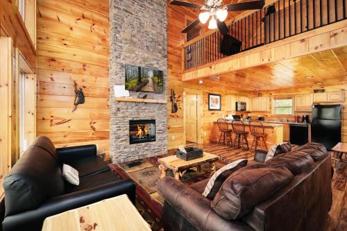 a living room with a couch and a fireplace at 2BR, slps 10, 8 min to Dollywood, hot tub! in Pigeon Forge