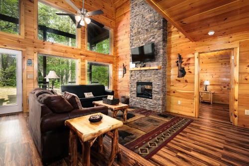 a living room with a couch and a fireplace at 2BR, slps 10, 8 min to Dollywood, hot tub! in Pigeon Forge