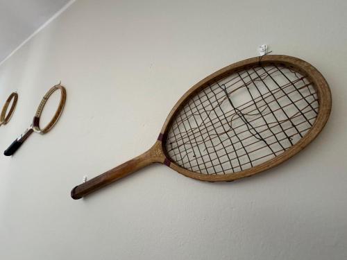 a wooden tennis racket and a pair of scissors at Bellagio, Grigna & Lake Suite in Civenna
