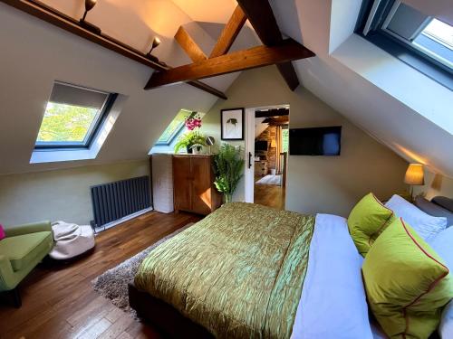 a bedroom with a large bed and some windows at Sunridge Fishing Lodge with Hot Tub & Giant Cinema in Plymouth