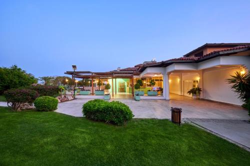 a home with a patio and a yard at Asteria Family Resort Belek in Belek