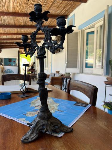 a black candle holder on top of a wooden table at La Giara in Vulcano