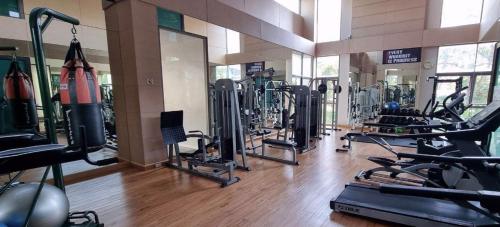 a gym with a bunch of treadmills and machines at Beachfront Luxe with Pool Access and Terrace in Pattaya North