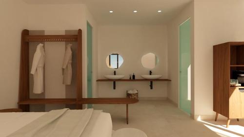a bedroom with a bed and two mirrors on the wall at Armony Suites Milos in Paliochori