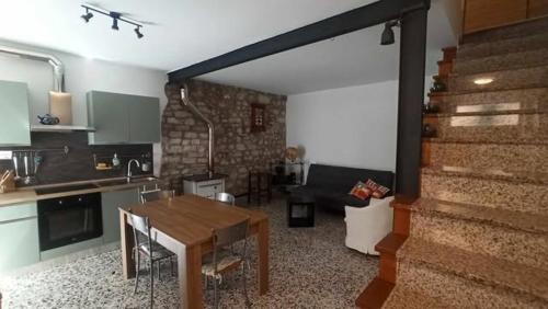 a kitchen and living room with a table and a couch at Casa Vacanze isopep in Lama Di Peligni