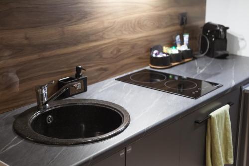 a kitchen counter with a sink and a stove at Utopia Luxury Suites - Old Town in Rhodes Town