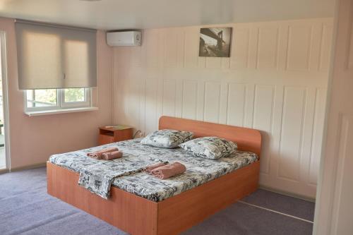 a bedroom with a bed with two pillows on it at Malibu Guest House in Kapchagay