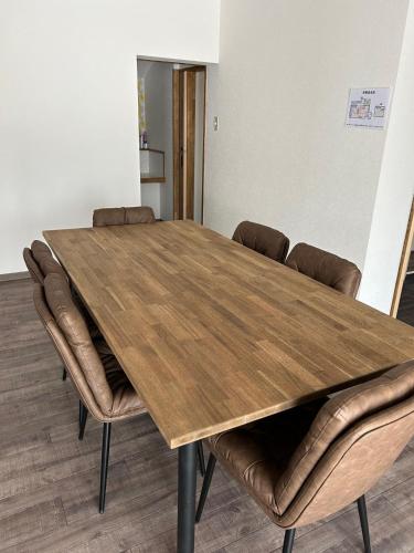 a conference room with a wooden table and chairs at とっくりhouse in Takashima