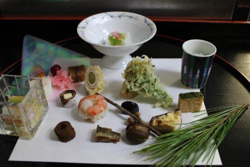 a plate of food on a table with a bowl of food at Yufuin-Sanso Waremokou in Yufuin