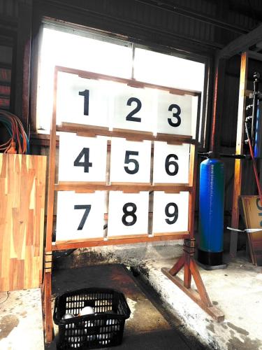 a wooden block with numbers on it in front of a window at とっくりhouse in Takashima