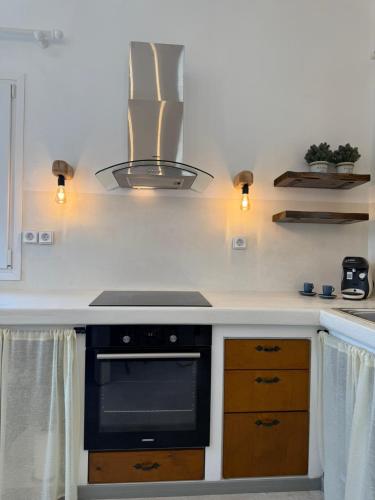 a kitchen with a stove and a stove top oven at white house apollon naxos in Apollon