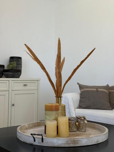 a tray with candles on a table in a living room at white house apollon naxos in Apollon