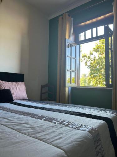 a bedroom with a large bed with a window at Casa Augusta - QUINTA in Penafiel