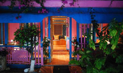 a blue and pink house with stairs leading to a door at Half Moon Blue Hotel in Scarborough