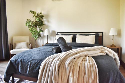 a bedroom with a bed with a blue comforter at Huge Hidden Hinterland Estate in Canungra