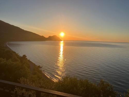 a sunset over a body of water at Casa Diletta - P terra in SantʼAmbrogio