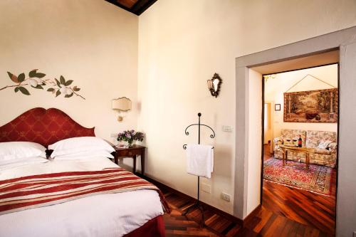 a bedroom with a bed and a living room at Villa Poggiano in Montepulciano