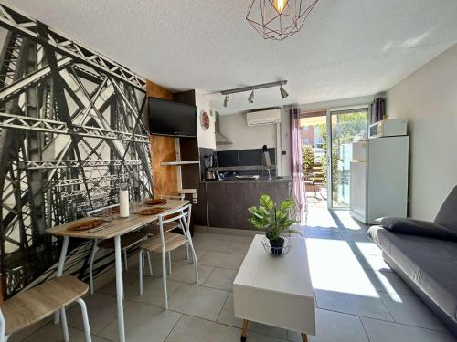 Il dispose d'une cuisine et d'un salon avec une table et un réfrigérateur. dans l'établissement studio - CAP D'AGDE CT520-002, au Cap d'Agde
