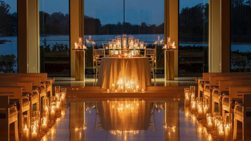 a room with a table and chairs with lights at InterContinental Sanctuary Cove Resort by IHG in Gold Coast