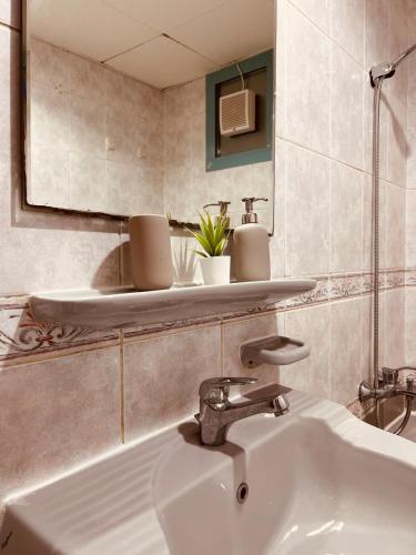 a bathroom with a sink and a mirror at ONE Guest Place Private Bedroom with Balcony in Abu Dhabi