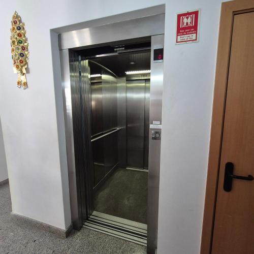 a elevator in a building with a glass door at Apartamentos Turísticos Vila Praia in Vila Praia de Âncora